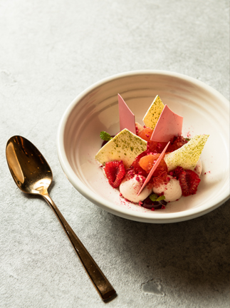 A carefully plated dish on a rustic ceramic plate